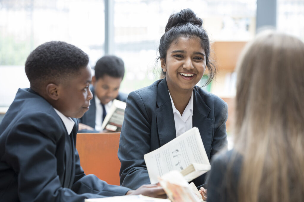 Students are seen laughing as they interact with one another during their lunch break.