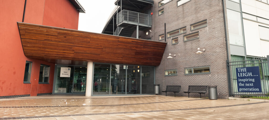Exterior photo of the main entrance of The Leigh Academy building.