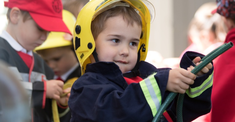 A young boy dressed as a fireman