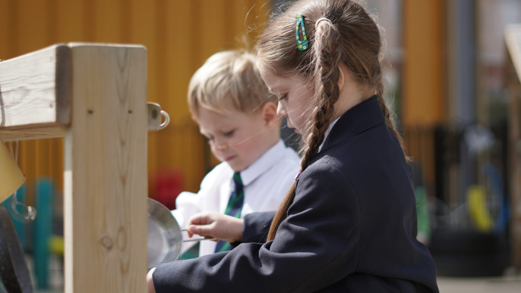 Two students playing on the playground