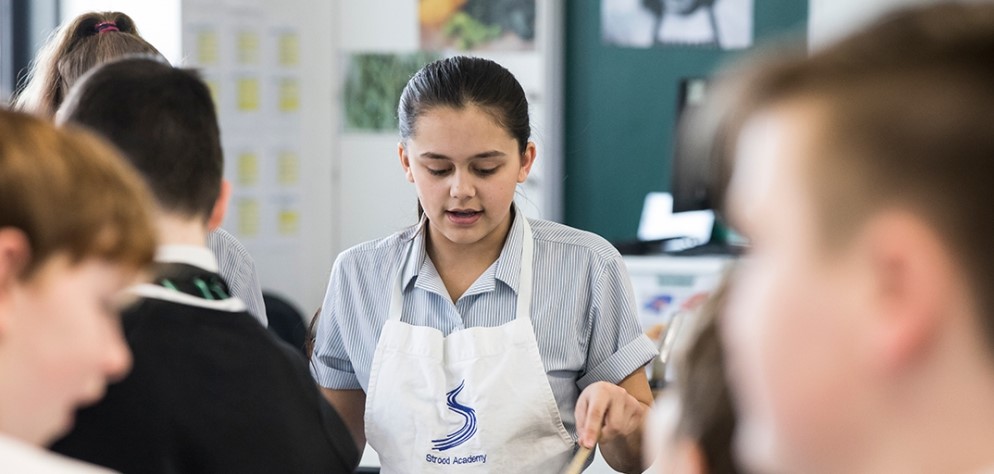 A students wearing an apron during a cooking class