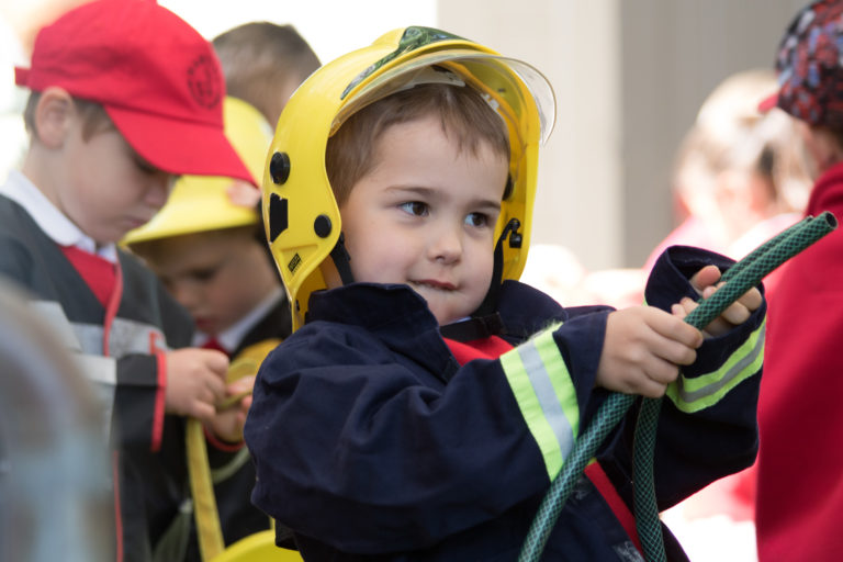 A young boy dressed as a fireman