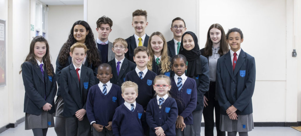 Students from the Hundred of Hoo Academy standing, smiling looking at the camera