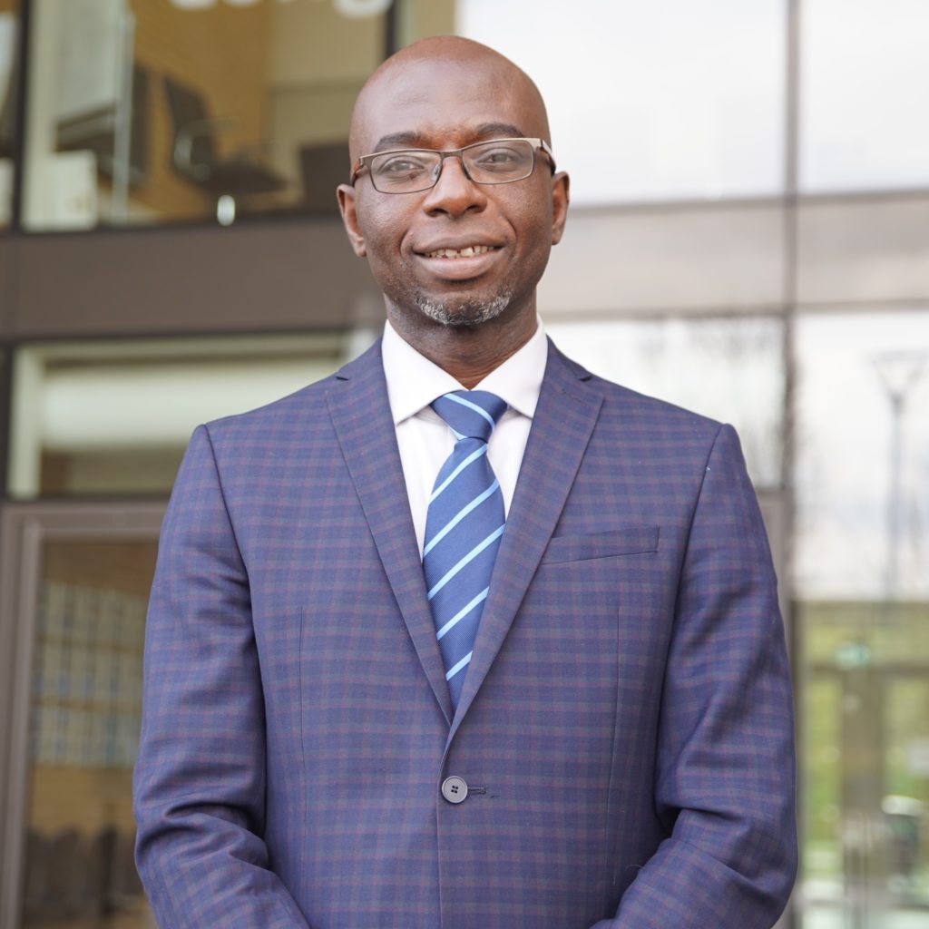 Photo of Longfield Academy's Principal, Dr Felix Donkor standing outside of the academy building.