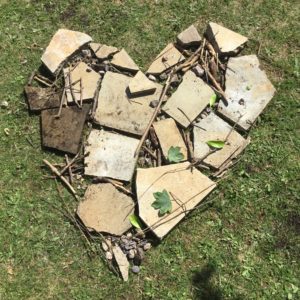 A heart made from paving slabs, sticks and small stones