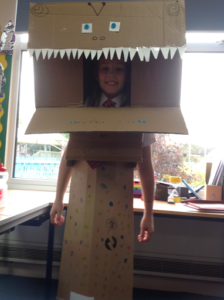 A child wearing their cardboard costume