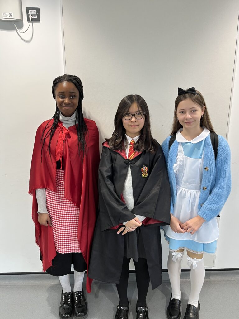 Three students dressed up for world book day.