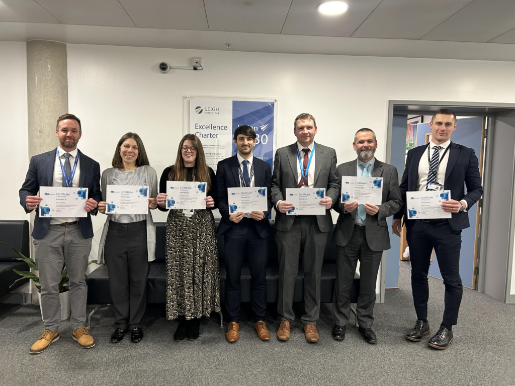 Photo showing the successful candidates of the LAT Aspiring Principals Programme, holding their certificates and smiling for the camera.