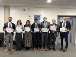 Photo showing the successful candidates of the LAT Aspiring Principals Programme, holding their certificates and smiling for the camera.