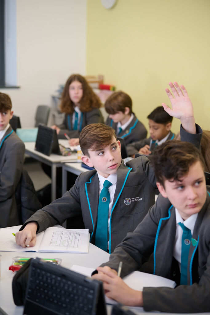 Student in class with their hand up